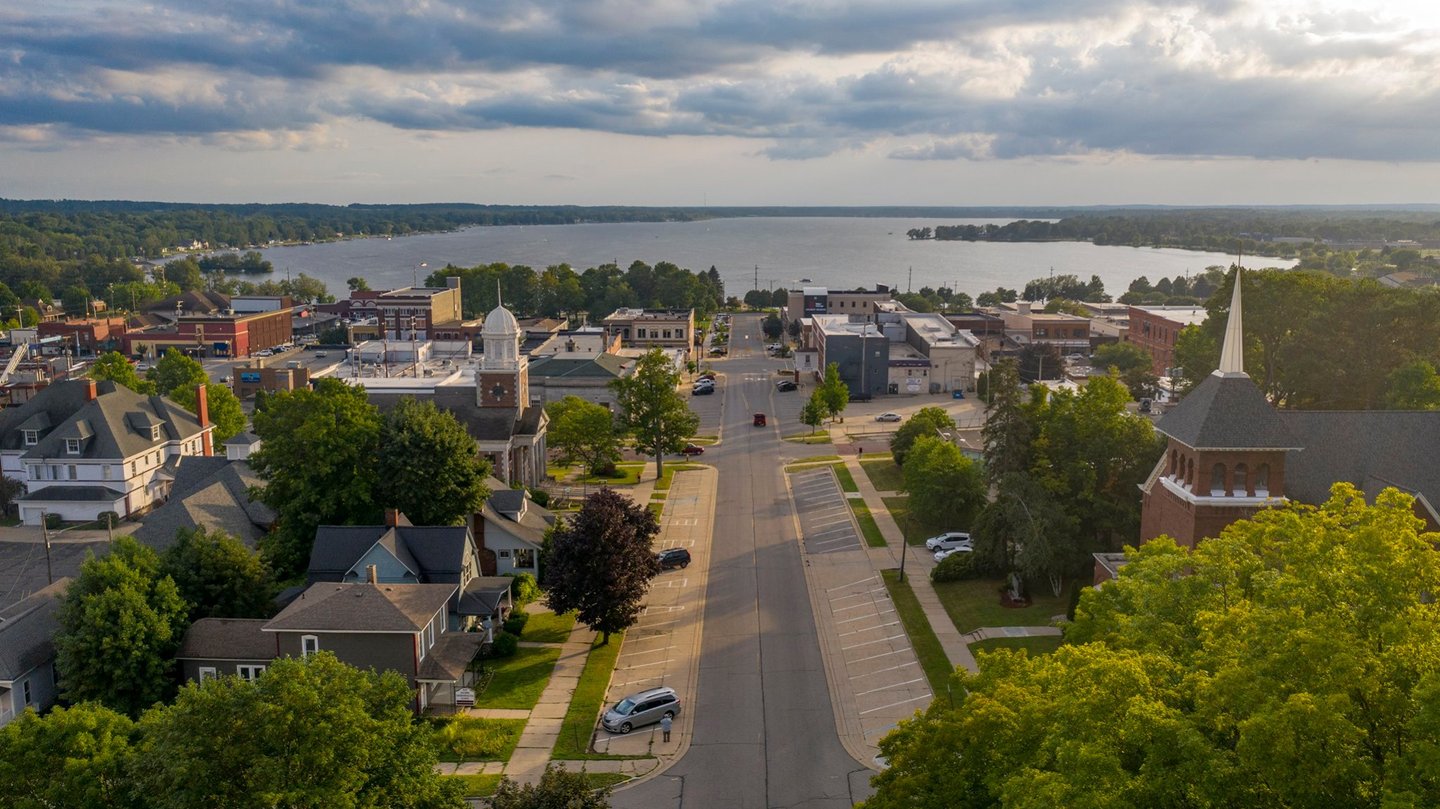 Aerial of Downtown Cadillac with a view of Lake Cadillac in the distance