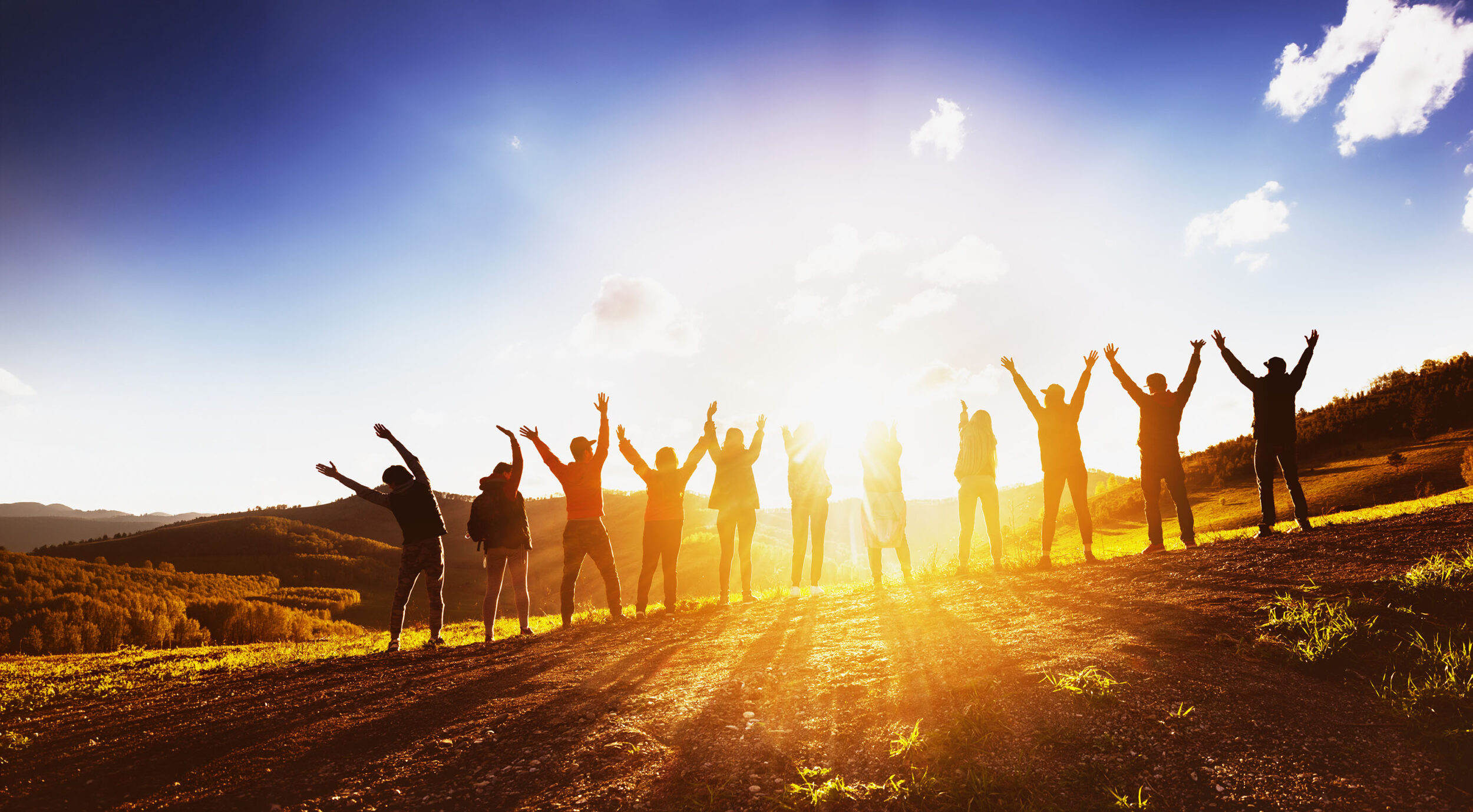 Big group of happy friends standing in sunbeams - Cadillac & Kellogg for Youth Grants (YAC)