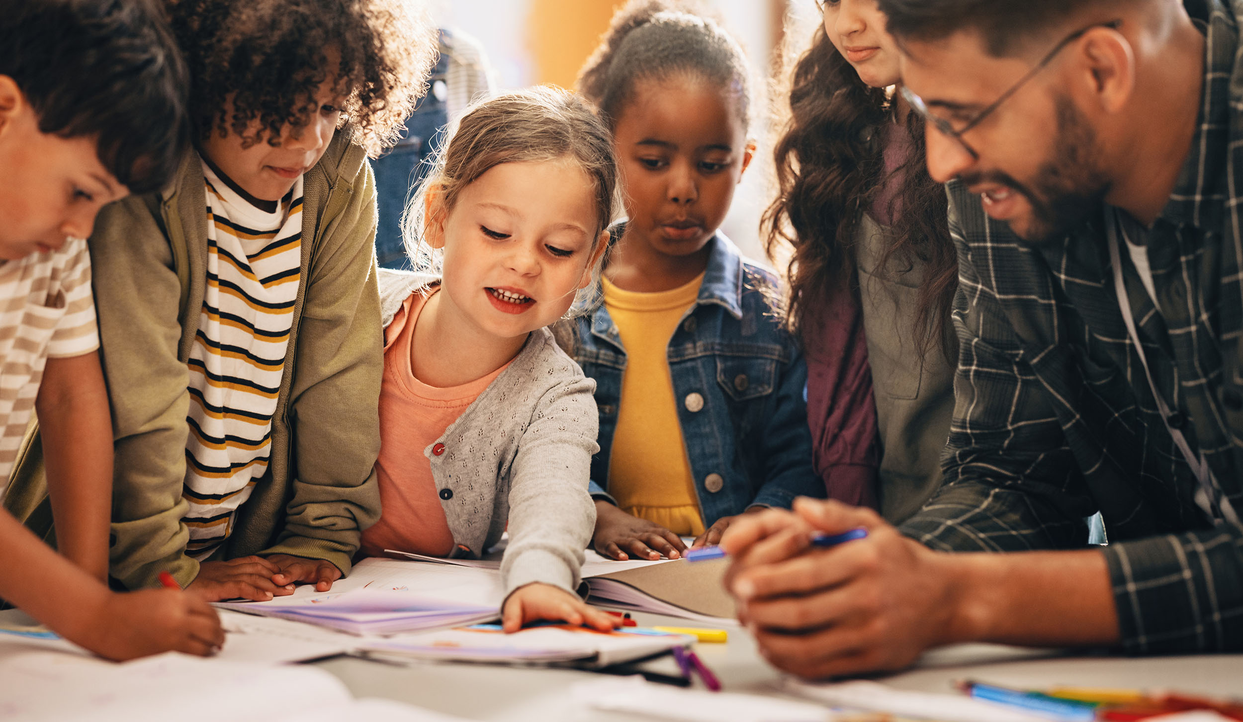 Students doing a creativity project with their teacher in a classroom - Teri Szabo Manton School Early Elementary Scholarship
