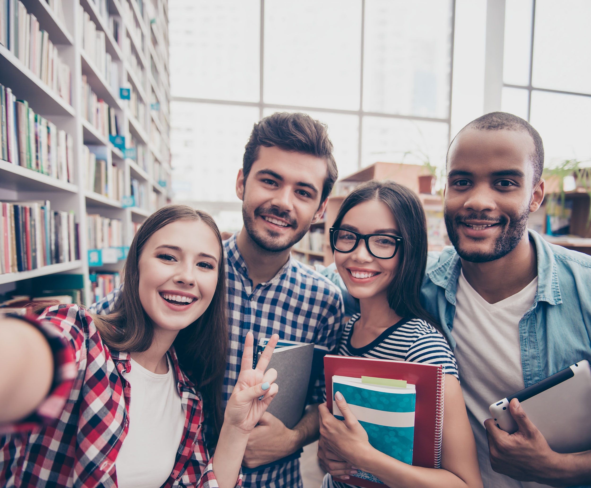 Students taking seflie in library - Workman Fund of Hope Scholarship- College Student & Professional Development