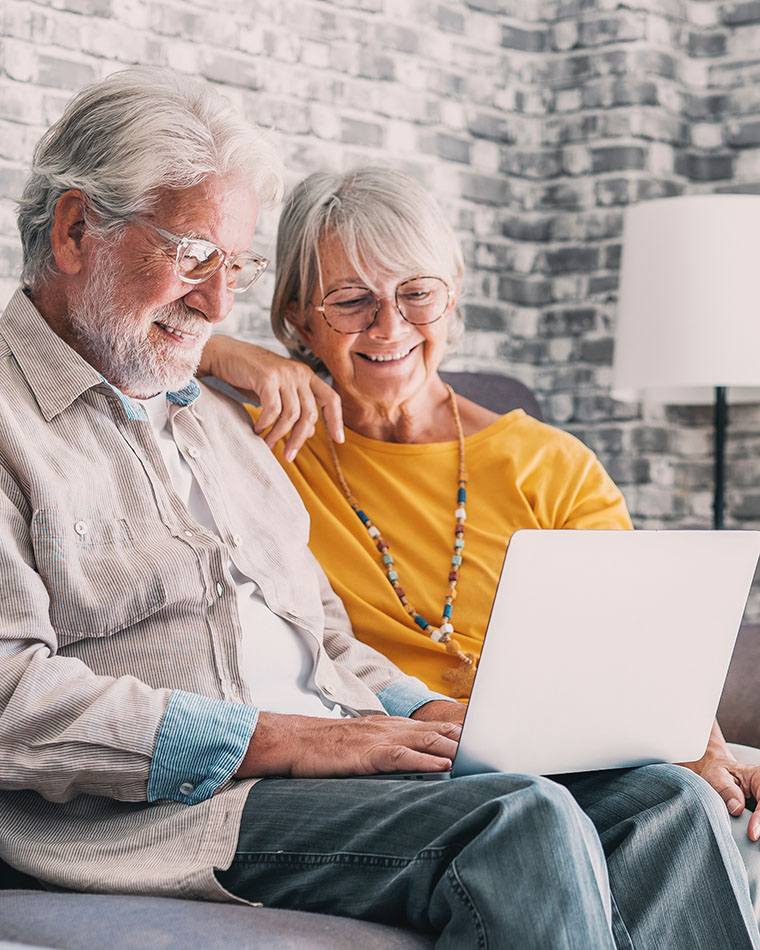 Older Couple Learning how to make a gift online